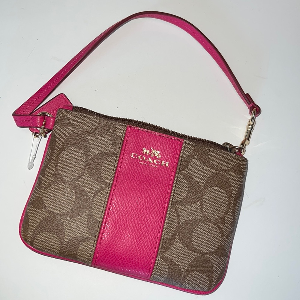 Small coach wristlet tan  with hot pink panel . Never used